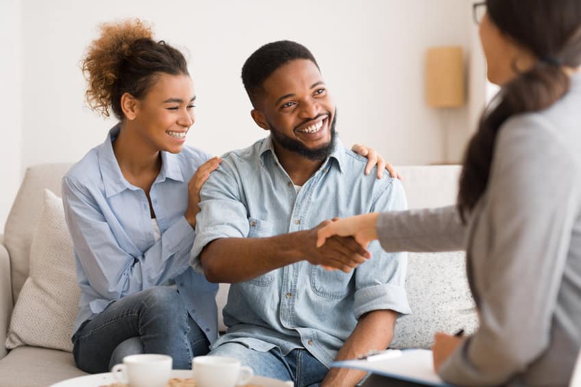 young african american couple handshaking with marriage counselor after therapy